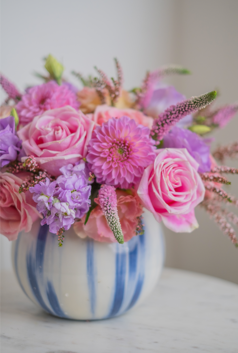 This arrangement in lavender shades looks elegant and romantic. Light lilac shades and rich coral dahlias look harmoniously with each other, creating an elegant combination. The embodiment of the shade of summer twilight or lavender fields shrouded in morning mist.